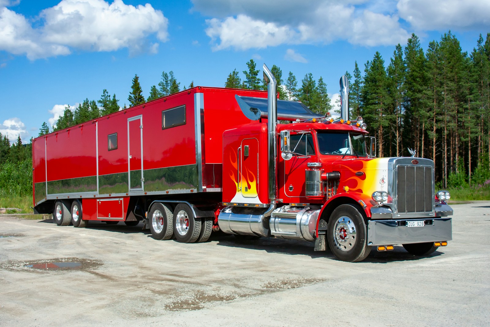 red and white truck on road during daytime trucking