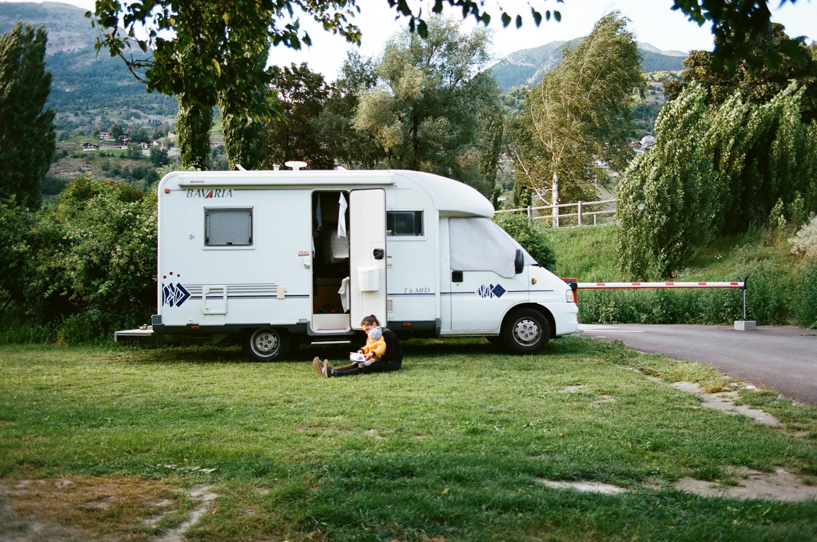 white rv trailer on green grass field during daytime, RV