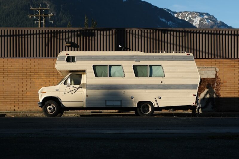 White camper van parked by brick wall